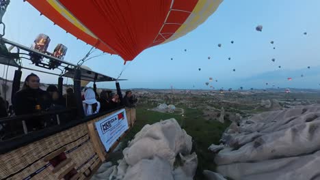 balloon-trip-over-cappadocia-turkey,-valleys-and-rocks,-drone