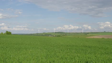 Vast-farmland,-wind-turbines-blend-modern-and-traditional,-a-sustainable-harmony