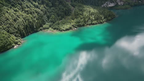 Aerial-view-of-beautiful-cloud-reflection-in-blue-turquoise-waters-of-Klontalersee-lake