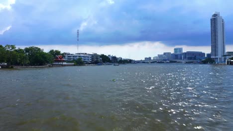 Fly-Over-The-River-of-Kings,-Chao-Phraya-River-In-The-City-Of-Bangkok,-Thailand