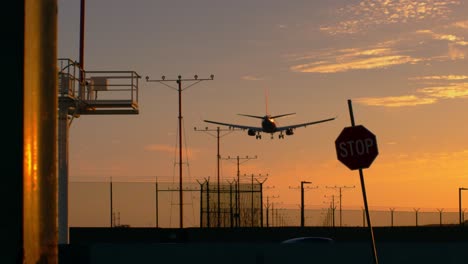 Airplane-on-final-approach-and-ready-to-land-in-LAX-stop-sign