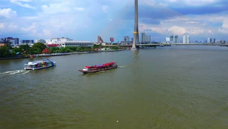 Tourist-Boats-Sailing-Across-The-Canals-Of-Chao-Phraya-River-Near-The-Rama-VIII-Bridge-In-Bangkok,-Thailand