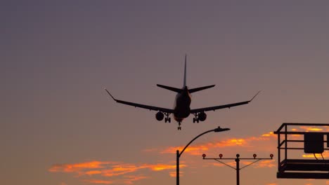 Airplane-landing-against-a-sunset-sky-at-LAX-airport---Los-Angeles---right-to-left