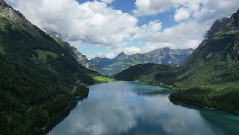 Mesmerizing-aerial-view-of-Klontalersee-Lake,-true-gem-nestled-within-Swiss-Alps