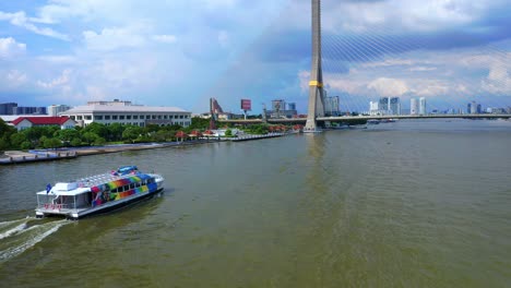 Ferry-Boat-Sailing-Near-Rama-VIII-Bridge-Crossing-The-Chao-Phraya-River-In-Bangkok,-Thailand