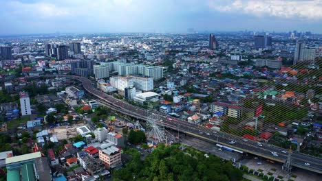 A-View-of-the-City-by-Rama-VIII-Bridge-on-the-Chao-Phraya-River,-Bangkok,-Thailand-Aerial