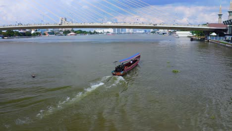 Chao-Phraya-River-With-Thai-Longtail-Boat-Crossing-Under-Rama-VIII-Bridge-In-Bangkok,-Thailand