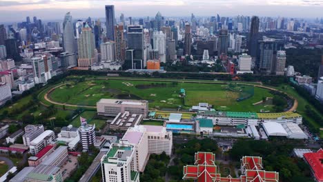 Green-Field-Of-Royal-Bangkok-Sports-Club-Nearby-Chulalongkorn-University-and-City-Skyline-Of-Pathumwan-In-Bangkok,-Thailand