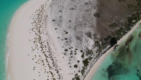 Aerial-bird's-eye-view-hyperlapse-of-ocean-waves-crashing-on-island-in-cayo-de-agua-los-roques-beach