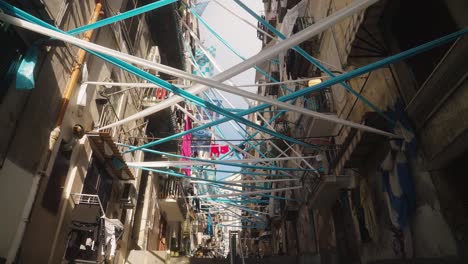 White-and-blue-flag-hanging-in-narrow-street-of-Naples,-football-attributes