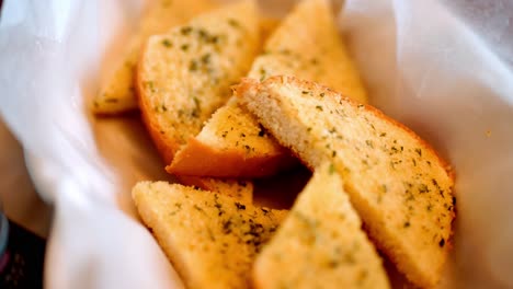 Freshly-Baked-Garlic-Bread-in-Basket,-White-Cloth-Background