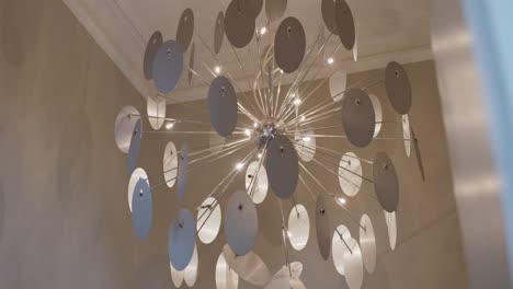 Slow-motion-revealing-shot-of-metallic-confetti-chandelier-on-ceiling