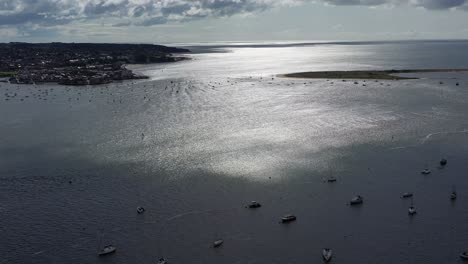 Aerial-drone-shot-tilting-up-,-showing-the-Exe-Estuary-with-beautiful-shimmering-water