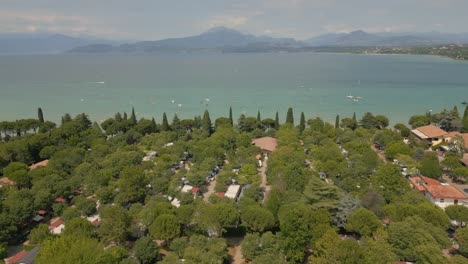 Drone-flying-over-beautiful-countryside-in-Italy-with-Lake-Garda