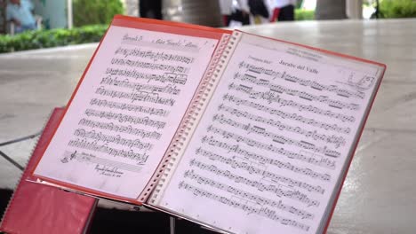 Hand-held-shot-of-Mexican-sheet-music-at-the-guelaguetza-event