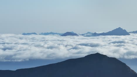 Aerial-View-of-Sea-Of-Clouds-Behind-The-Mountain-Peak-In-Norway