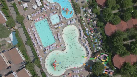 Birds-eye-view-drone-shot-outdoor-swimming-pools-on-hot-summer-day