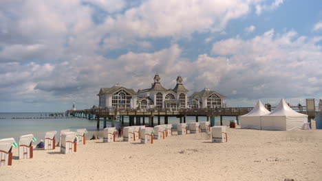 Sellin-Pier---Daytime-Timelapse-of-White-Clouds-And-People-Movement-on-Baltic-Sea-Beach-in-Rugen-Island,-Germany