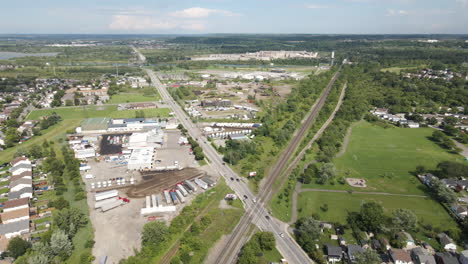 Panoramic-aerial-pullback-above-giant-large-x-intersection-with-long-sprawling-road-way