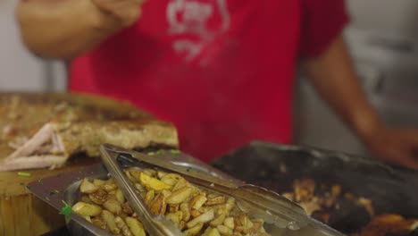 Chef-prepare-fast-food-with-french-fries-in-local-truck,-close-up
