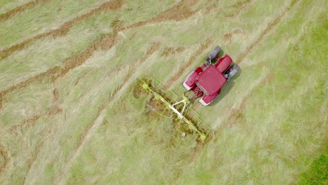 Isolated-red-mower-cutting-grass.-Aerial-drone-view