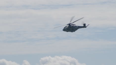 Slowmotion-tracking-shot-of-a-navy-helicopter-cornering-at-full-speed