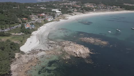 Raw-Aerial-Footage-of-Wide-Beach-in-Resort-with-Clear-Water-and-Sailboats