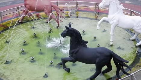 Fountain-Four-Seasons-with-horses-on-City-Square-in-Kuningan-Garden,-West-Java,-Indonesia