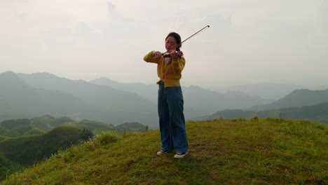 Eine-Musikerin-Spielt-Geige-In-Einem-Nebligen-Bergparadies