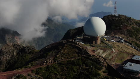 Pico-Arieiro,-Madeira:-aerial-view-in-a-circle-towards-the-radar-station-that-is-in-the-area-and-with-the-background-of-the-nearby-clouds