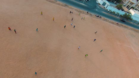 Mesmerizing-Orbit-Around-a-Spirited-Football-Match-Amongst-Players-in-Jeddah,-Saudi-Arabia