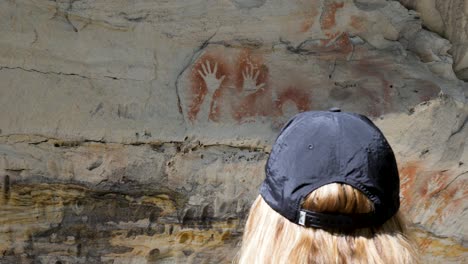 Women-viewing-the-ancient-culture-of-Aboriginal-storytime-rock-art-cave-paintings-from-indigenous-Australian-first-nation-people