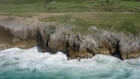 Cinematic-aerial-trucking-pan-along-weathered-layers-of-limestone-rock-in-asturias-spain