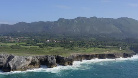 Aerial-establishing-view-of-rocky-chimney-coastline-of-bufones-de-pria-asturias-spain-limestone-cliffs