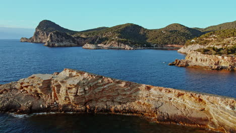 Fly-Over-Jutting-Stone-Formations-Of-Punta-de-Sa-Galera-In-San-Antonio,-Ibiza-Spain