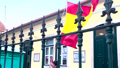 At-the-heart-of-Lisbon,-a-Spanish-flag-proudly-flutters-atop-hands,-symbolizing-unity-and-cross-cultural-connections-between-nations---Jornadas-Mundiais-da-Juventude