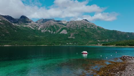 Panorama-Of-Boat-Floating-In-The-Calm-Blue-Water-In-Daytime-With-Mountain-Views-In-The-Background