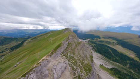 FPV-drone-flying-in-the-stunning-mountain-scenery-of-Seceda,-located-in-the-Dolomites-natural-park,-Italy