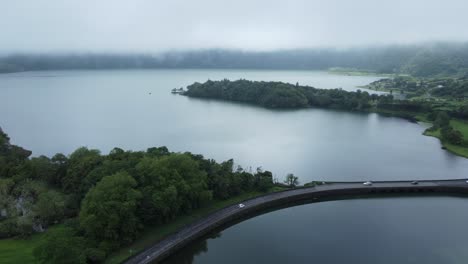 Grey,-low-cloud-aerial-view-of-Lagoa-Azul-lake-in-Portugal-Azores