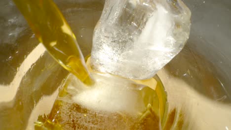 Micro-shot-of-coffee-being-poured-into-a-glass-of-ice