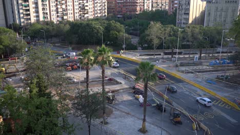 Scene-of-ongoing-road-reconfigured-work-upgrading-and-the-street-with-moving-traffic-in-Barcelona,-Spain