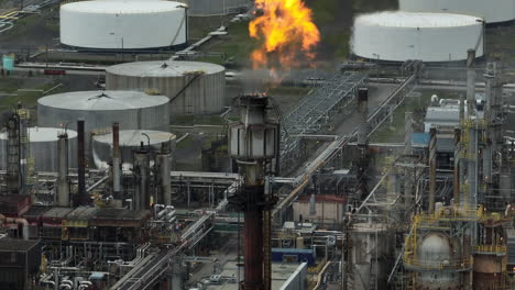Ascending-aerial-of-flame-exhaust-at-oil-refinery