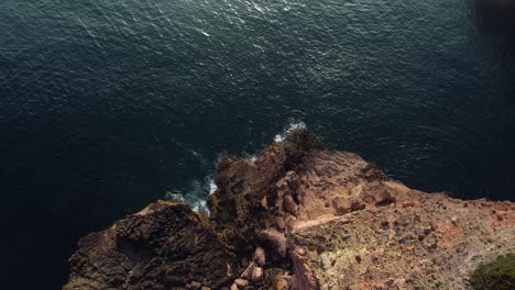 Topdown-Rock-formation-with-deeo-blue-atlantic-ocean,-Algarve