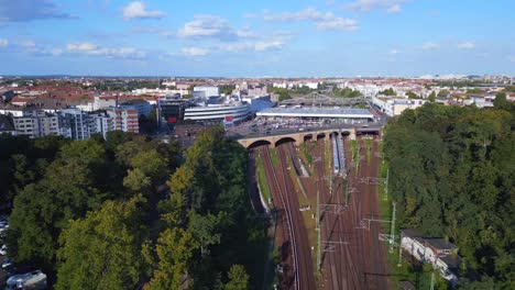 Fantastic-aerial-top-view-flight-tracks-yellow-suburban-train-Platform-S-Bahn-Station-bridge,-Berlin-mitte-summer-2023
