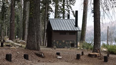 stone-outhouse-bathroom-on-a-campground-by-a-lake-STATIC