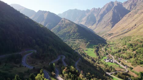 Winding-road-in-French-Pyrenees-showcasing-Le-Plan-town-surrounded-by-mountains