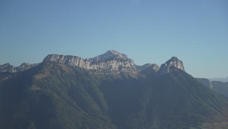 Rocky-Mount-Semnoz-near-the-town-of-Lake-Annecy-in-the-French-Alps-seen-from-the-air,-Aerial-plane-shot