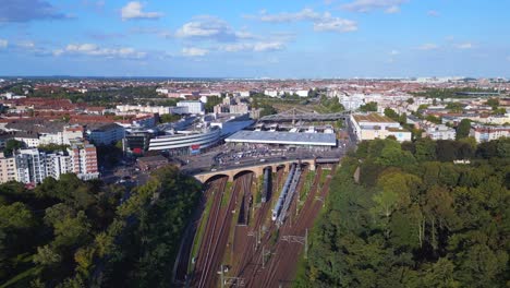 Perfect-aerial-top-view-flight
tracks-yellow-suburban-train-Platform-S-Bahn-Station-bridge,-Berlin-mitte-summer-2023