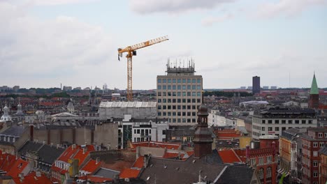Tower-crane-at-building-construction-site-seen-from-The-Round-Tower-in-Copenhagen,-Denmark