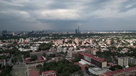 Drone-video-capturing-Mexico-City's-University-City-with-the-cityscape-in-the-background
